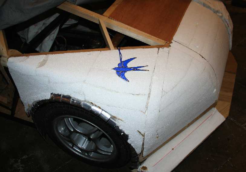The drivers wing and a stained glass ornament blue bird