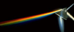 The refractive index of a material indicates how much slower the speed of light is in that medium than in a vacuum.  The slower speed of light in materials can cause refraction, as demonstrated by this prism (in the case of a prism splitting white light into a spectrum of colours, the refraction is known as dispersion).